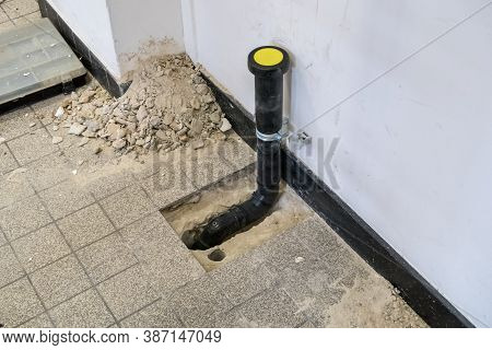 A Black Polypropylene Drain Pipe Worked Into The Floor
