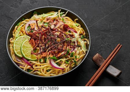 Burmese Atho In Black Bowl On Dark Slate Table Top. Atho Is Myanmar Indian Cuisine Dish Popular In C