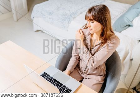 View From Above Of Beautiful Brunette Woman Freelancer Suffering From Shoulder Pain In Home Office. 