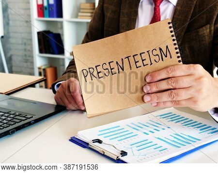 Presenteeism Concept. The Employee Holds A Notepad With The Inscription.