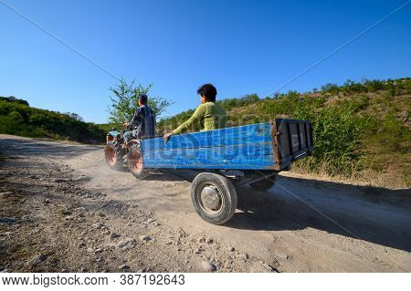 Socola village, Soldanesti, Moldova, September 2020: Mini tractor at mountain road iwith passenger. This mode of working transport bacomes popular at bad roads in this region.