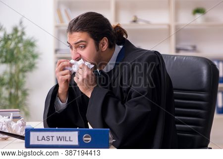 Young male judge working in courthouse