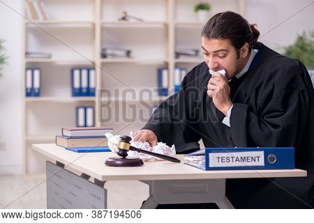 Young male judge working in courthouse