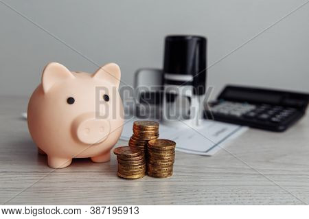 Pink Piggy Bank With Stack Of Coins On Wooden Desk In Office. Economy And Management Financial Conce