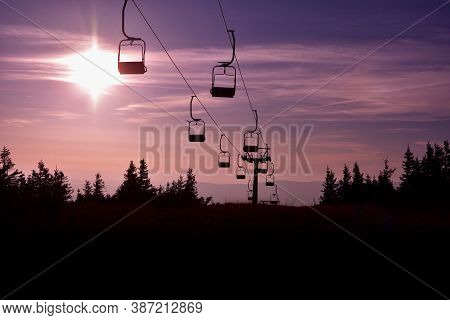 Ski Chair Lift In The Mountains At Pink Sunrise