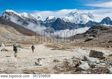 Tourist Trekking In Sagarmatha National Park With Beautiful View Of Mount Everest (8,848 M) The High