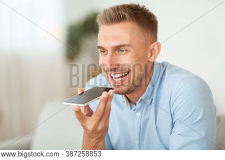 Voice Search Concept. Closeup Portrait Of Young Bearded Guy Using Voice Assistant Or Calling On Smar