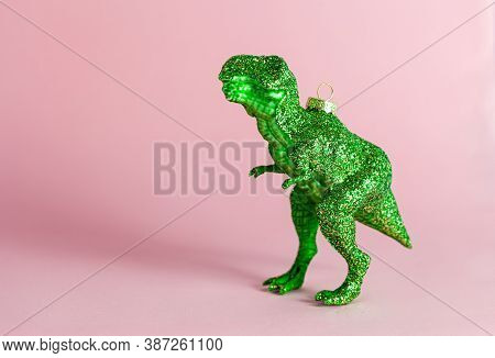 Kitschy T-rex Christmas Ornaments For The Holidays, On Pink