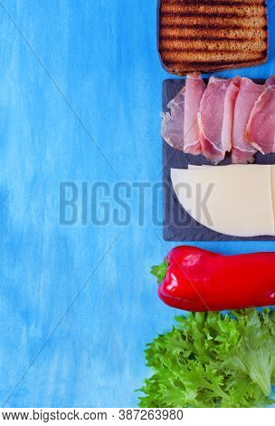 Ingredients For Making Sandwich With Cheese, Pork Balyk, Bell Pepper, Lettuce Leaves And Toasted Bre