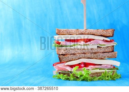 Multilayered Club Sandwich With Cheese, Pork Balyk, Bell Pepper, Lettuce Leaves And Toasted Bread Ag