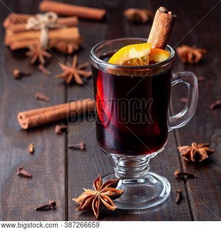 Red Glogg Or Mulled Wine With Orange Slices And Cinnamon Stick On A Dark Wooden Background, Square F