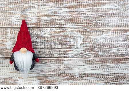 Gnome Or Swedish Tomte Soft Toy, On A Wooden Background, Horizontal, Copy Space, Top View