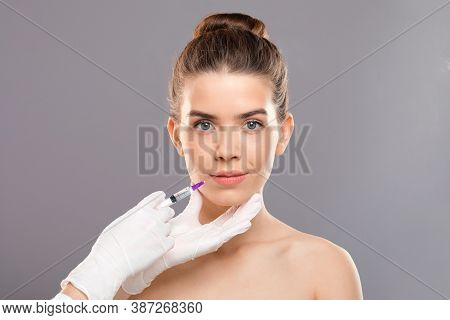 Aesthetic Modern Medicine Concept. Lip Injection For Young Woman Over Grey Studio Background, Copy S