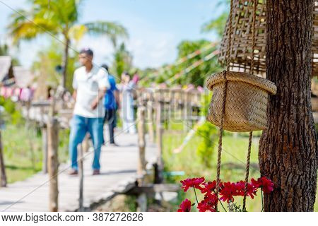 Baskets Hanging The Background Is Blurred And People Walk Around To Continuously Admire The Beauty O