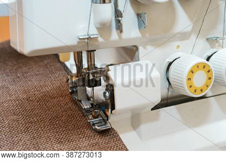 Overlock Sewing Machine In Process. Professional Equipment