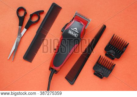 Kharkov, Ukraine - July 2, 2020 : Hairdressers Tool. Hair Clipper Wahl Close-up On A Red Background 