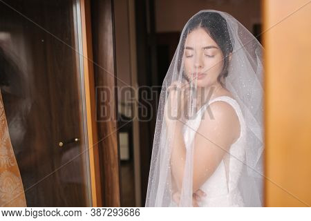 Bride On The Veil Stand By The Window And Wait For The Goom