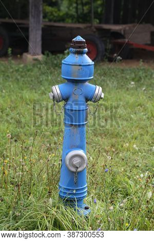 Fire Hydrant Stands On A Green Lawn