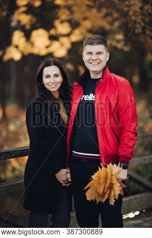 Couple In Love Goes For A Walk In The Autumn Park Together
