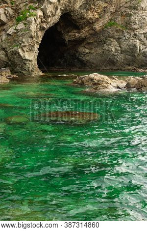 Rocks And Grotto On The Seashore, Cloudy Weather At Sea, Coastline Of Telyakovsky Bay Primorsky Krai