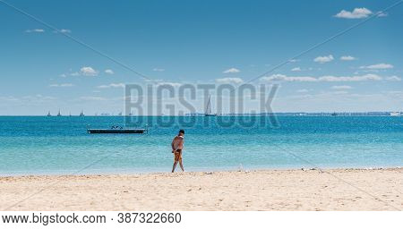Rockingham, Wa / Australia - 03/19/2017 Man Walking Along The Foreshore At Mangles Bay Rockingham Wi