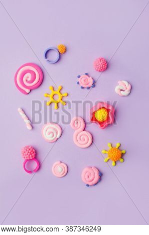 Abstract Purple Pastel Background With Kids Accessories From Clay, Concept Of Pop Art Culture, 80s, 