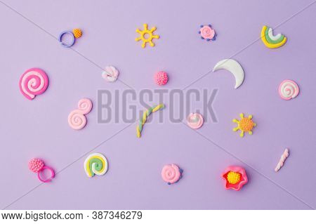 Abstract Purple Pastel Background With Kids Accessories From Clay, Concept Of Pop Art Culture, 80s, 