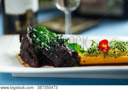Closeup On Spanish Veal Cheeks In Wine Sauce And Sweet Potato Puree