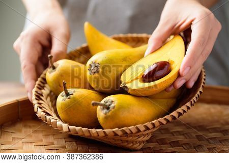 Eggfruit Or Canistel In A Basket Holding By Hand, Thai Fruit, In Thai Names Such As Xiantao, Lamut K