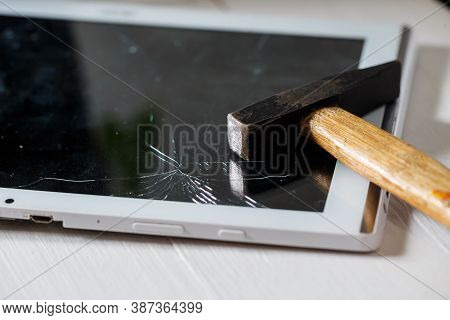 The Hammer Hits The Broken Touchscreen Tablet, Suggesting That It Is About To Replace It. Broken Gla