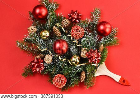 Creative Composition Christmas And New Year. Paint Brush With Christmas Fir And Ornaments On A Red B