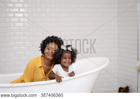 African American Family, Happy Mother And Baby Daughter Having Fun And Playing Together At The Bathr