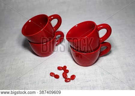 Red Ceramic Espresso Cups And A Few Beans