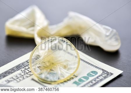 Used Condom And Us Dollars Bills. Cum In Condom. Prostitution Concept. Pay For Sex Per Night. Harlot