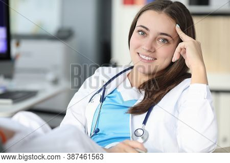 Young Beautiful Woman Doctor With Phonendoscope Around Her Neck Smiling During Break From Work Portr