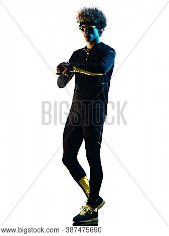one youg caucasian runner jogger running jogging man using smartwatch chrono in studio shadow silhouette isolated on white background