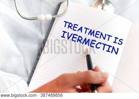 Doctor Holding A Card With Text Treatment Is Ivermectin, Medical Concept
