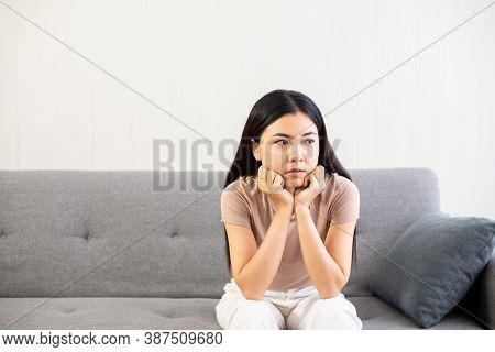 Depression Asian Woman Have A Headache And Absent-mindedof Lonely Sitting On Sofa At Home,female Und