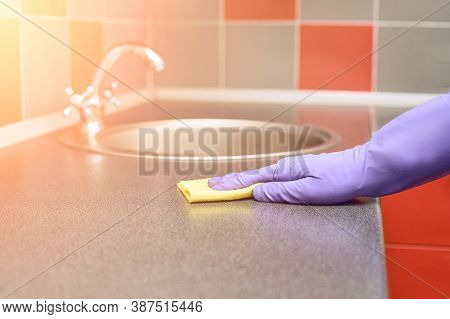 Hand In Protective Glove Clean Kitchen Table. House Cleaning With Rag. Washing Bar Worktop. Disinfec