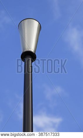 A Cone Shaped Lamppost Against Blue Summer Sky