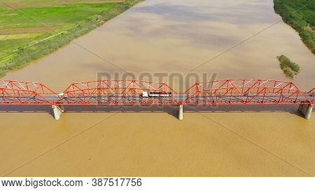 Bridge Over The Cagayan River, Philippines, Aerial View. Road Bridge Over A Wide River. Cars Ride On