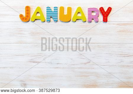 Wooden Letters Written January Month On Vintage Background. Inscription January With Copy Space. Top
