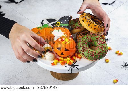 Halloween Kids Party Table With Candy Corns, Ginger Cookies And Spooky Donuts. Happy Halloween Backg