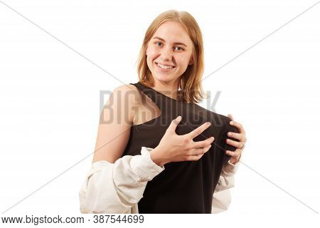 Young Woman Showing Her Big Fake Breasts On White Background, Looking At Camera, Smiling