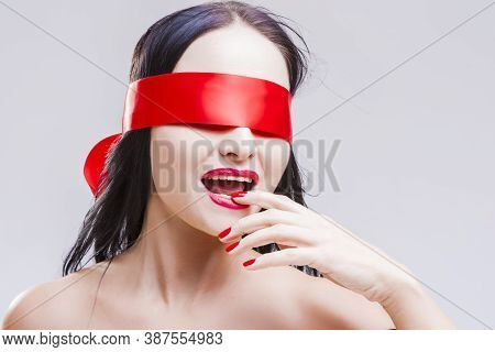 Portrait Of Mature Sensual Caucasian Brunette Woman Posing With Red Ribbon Blinder On Eyes With Pass