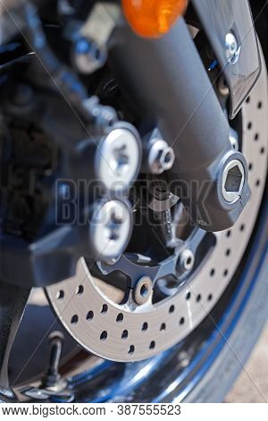 Closeup Of Modern Motorcycle Front Braking System With Pads And Disks.