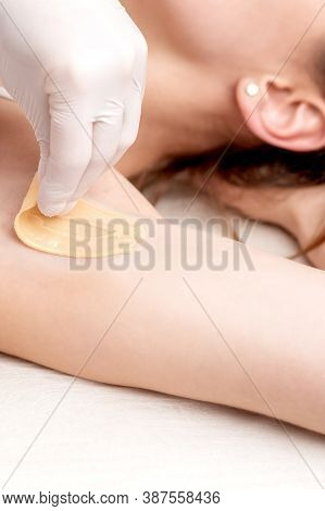 Hand Of Cosmetologist Applying Wax Paste On Armpit. Depilation Or Epilation Female Armpit With Liqui
