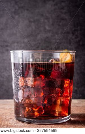Boulevardier Cocktail And Orange Zest On Rusty Background.