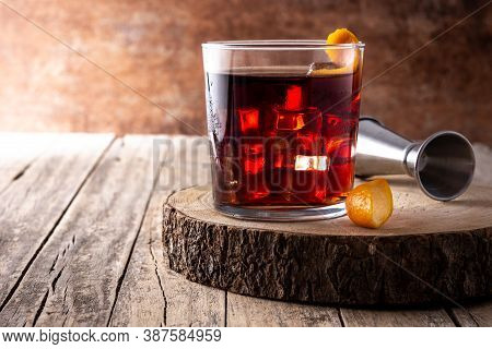 Boulevardier Cocktail And Orange Zest On Rusty Background. Copy Space