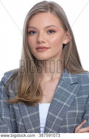 attractive young woman in blue checkred suit posing and smiling isolated on white background, portrait